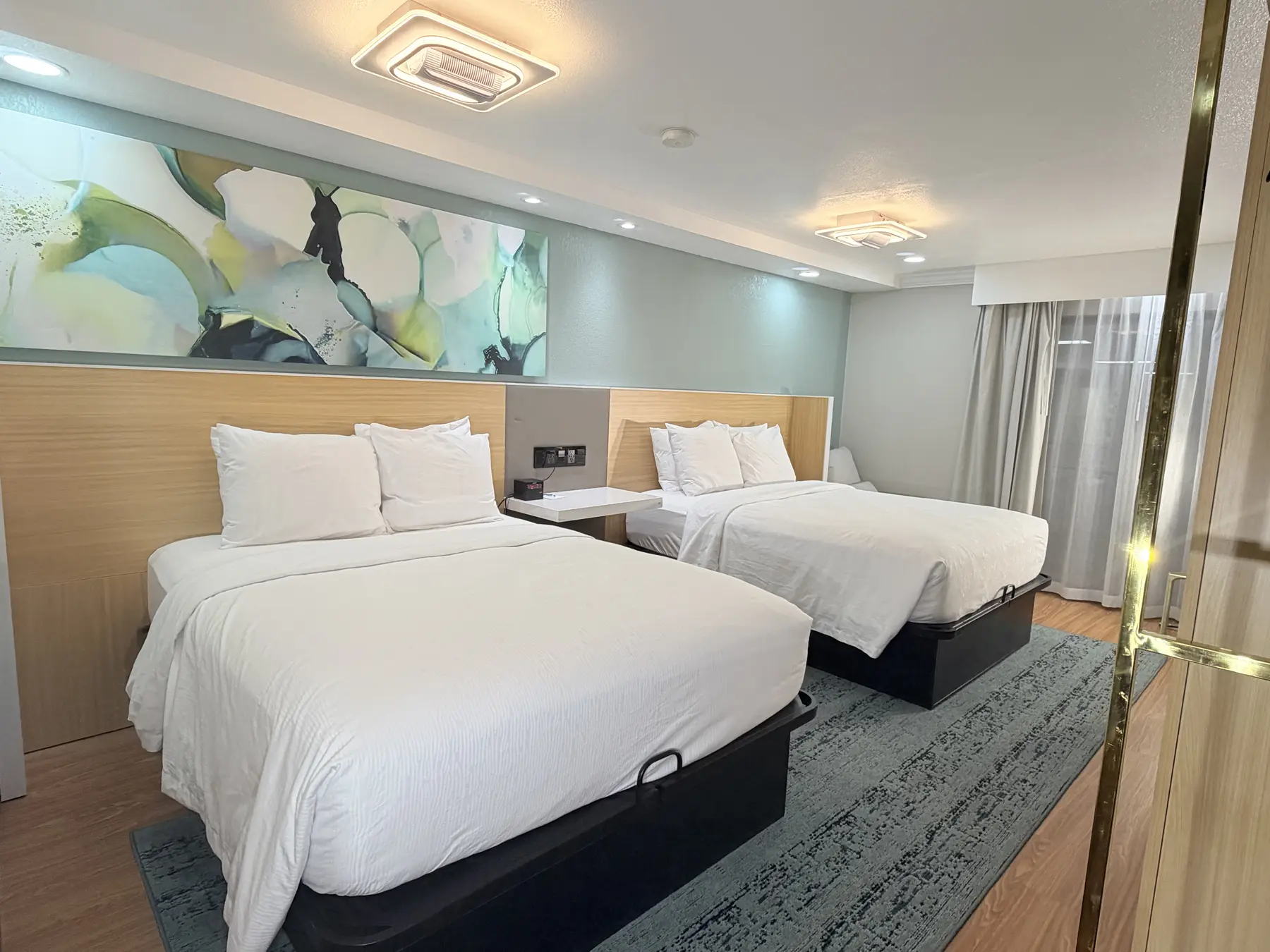 Modern two-queen guest room at Wyndham Garden Salina